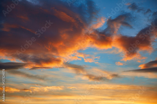 Fototapeta Naklejka Na Ścianę i Meble -  Sunset sky orange clouds over blue