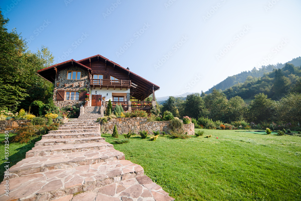 Beautiful house in high mountains during summer. Beautiful house in high mountains during summer.