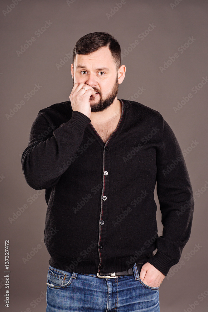 bearded man biting his nails fingers freaking out. bearded man biting his nails fingers freaking out.