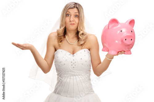 Upset bride holding a piggybank and gesturing with her hand