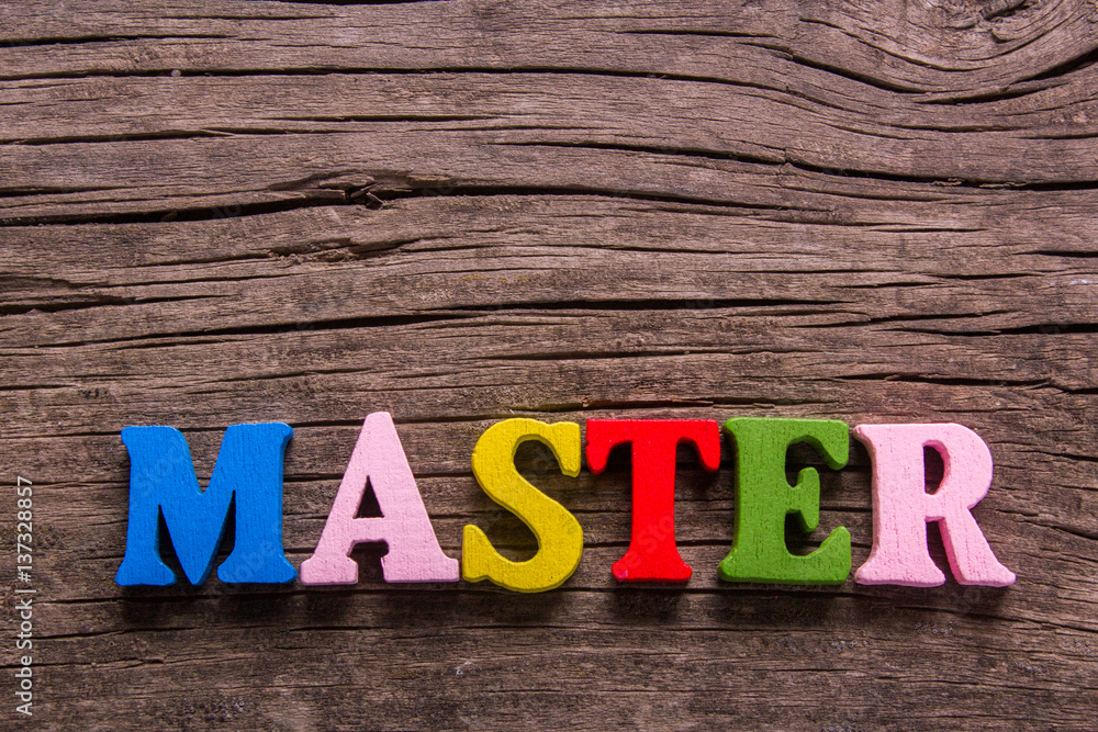 Fototapeta premium master word made from colored wooden letters on an old table. Concept