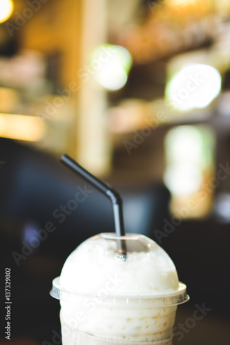 Ice coffee on a wooden table in coffee shop background hipster tone soft and selective focus 