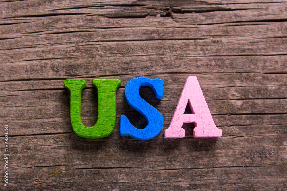 Fototapeta premium usa word made from colored wooden letters on an old table. Concept