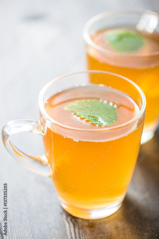 chamomile tea in a glass cup on wooden background
