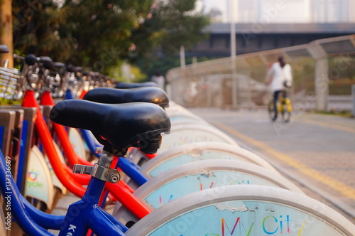 Bicycle rental facilities and a row of bicycles in the streets. In Shenzhen, china.