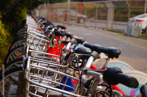 Bicycle rental facilities and a row of bicycles in the streets. In Shenzhen, china.