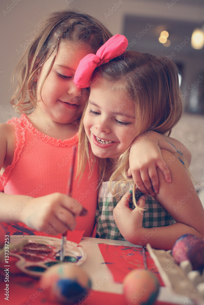 Fototapeta premium Kids Easter preparation by painting Easter eggs.