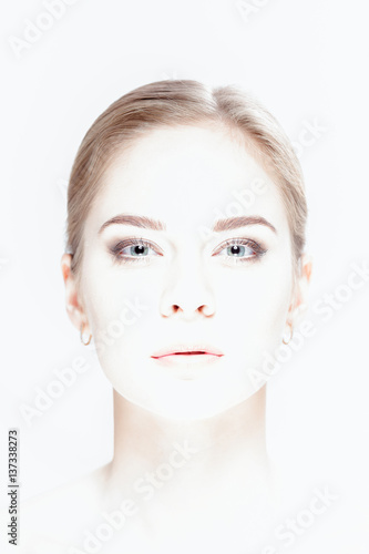 overexposed portrait of beautiful young blonde woman with green 