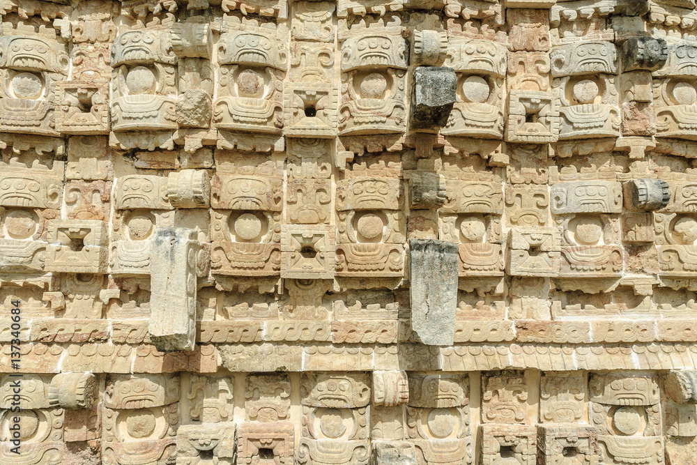large masks of the Mayan god Chaac in the front of the palace of the masks or Codz Poop in the archaeological Kabah enclosure in Yucatan, Mexico. large masks of the Mayan god Chaac in the front of the palace of the masks or Codz Poop in the archaeological Kabah enclosure in Yucatan, Mexico.