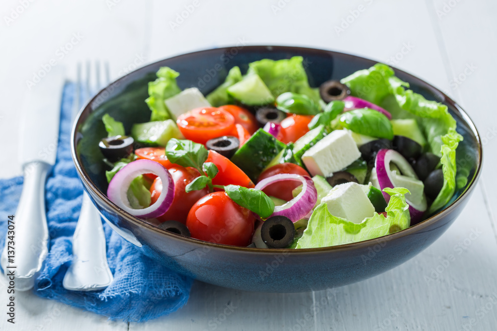 Healthy Greek salad with lettuce, cherry tomatoes and feta cheese