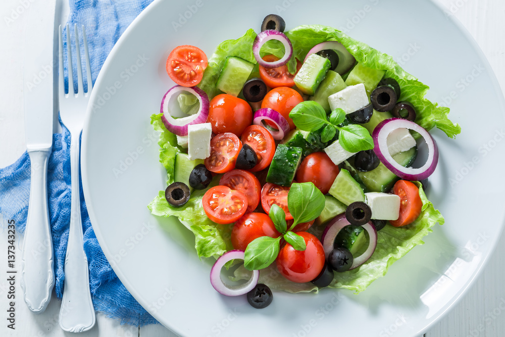 Classical Greek salad with feta cheese, black olives and lettuce Classical Greek salad with feta cheese, black olives and lettuce