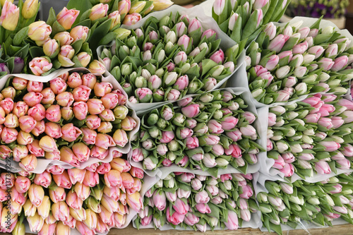 Fototapeta Naklejka Na Ścianę i Meble -  Assortment of bouquets of colorful tulips in a farmers market
