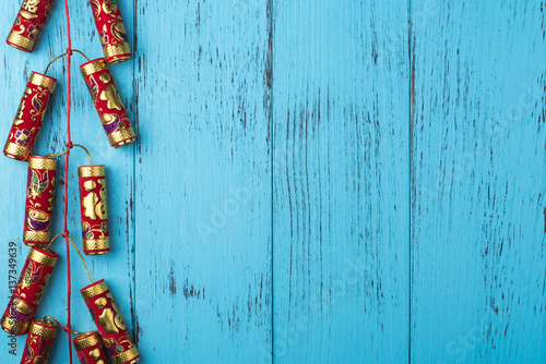 Chinese New Year decoration: firecrackers on weathered blue wooden planks, copy space, overhead