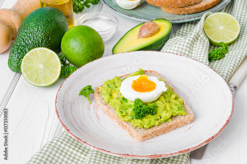 Sandwich with whole grain bread, mashed avocado and boiled eggs
