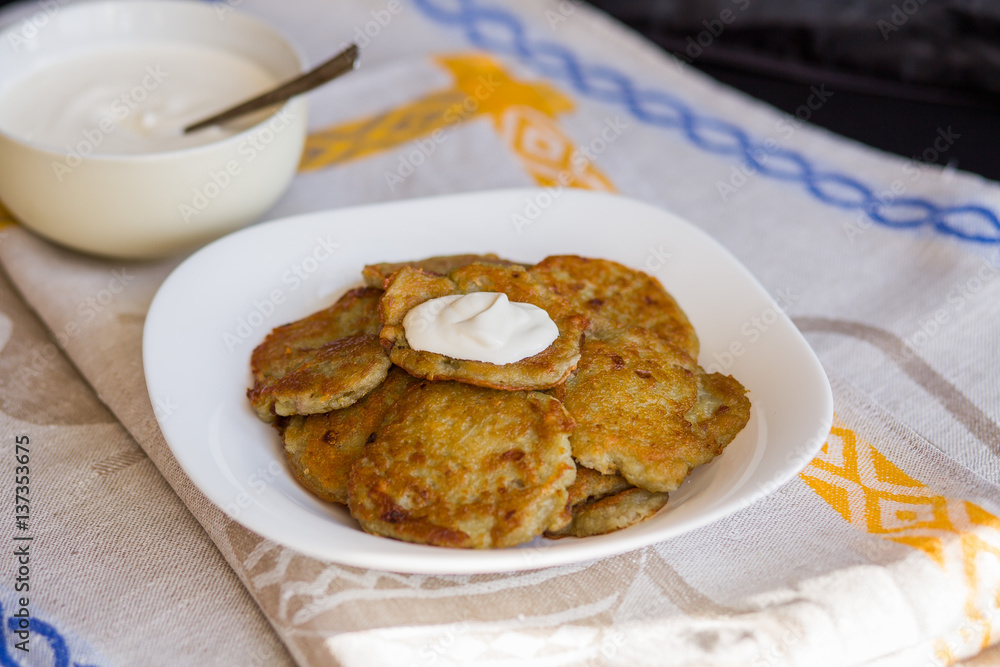 Potato pancakes with sour cream. National Russian dish.