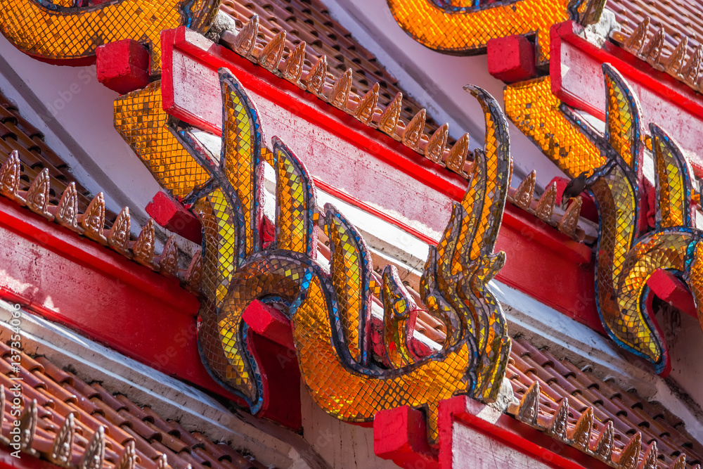 Traditional Thai temple roof details. Wat Mongkol Nimit temple in Phuket town, southern Thailand.