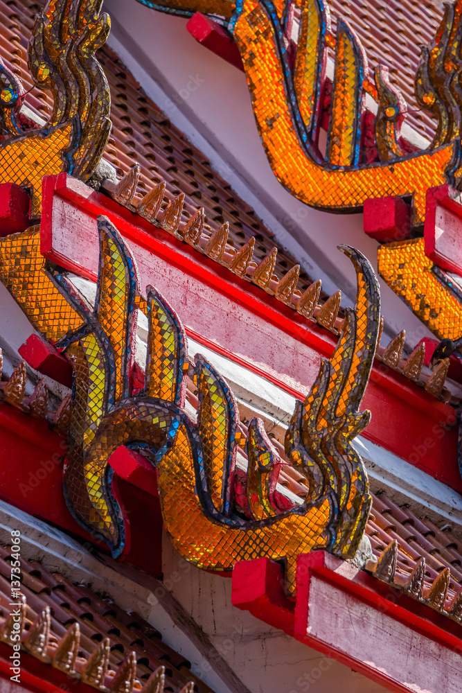 Fototapeta premium Traditional Thai temple roof details. Wat Mongkol Nimit temple in Phuket town, southern Thailand.