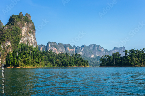Karst mountains above clear blue water in Khao Sok national park, Cheo Lan lake, Thailand
