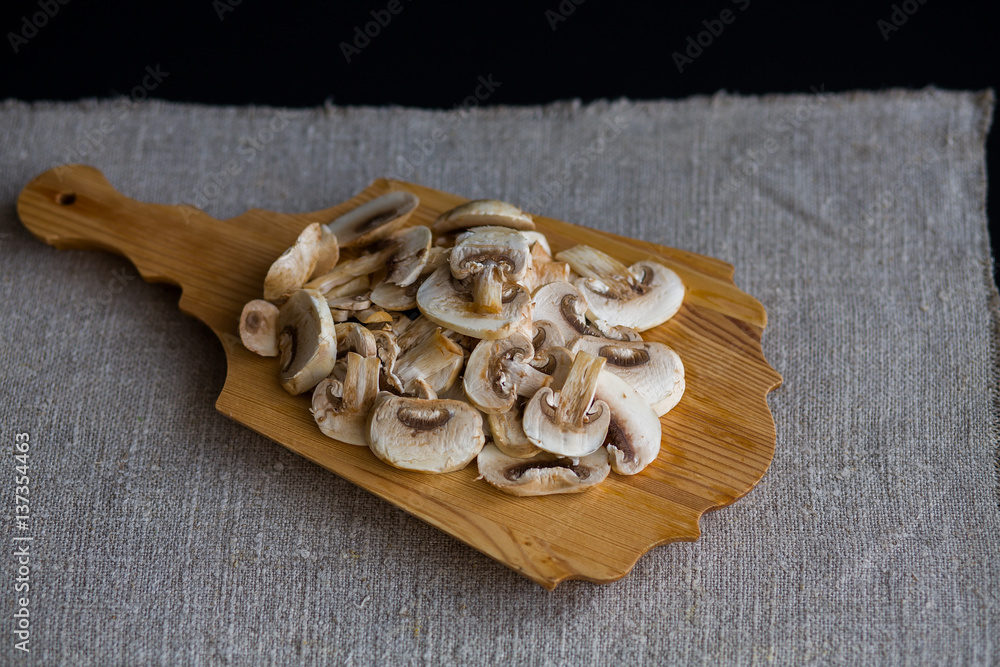 Mushrooms mushrooms raw sliced slices on a wooden Boards