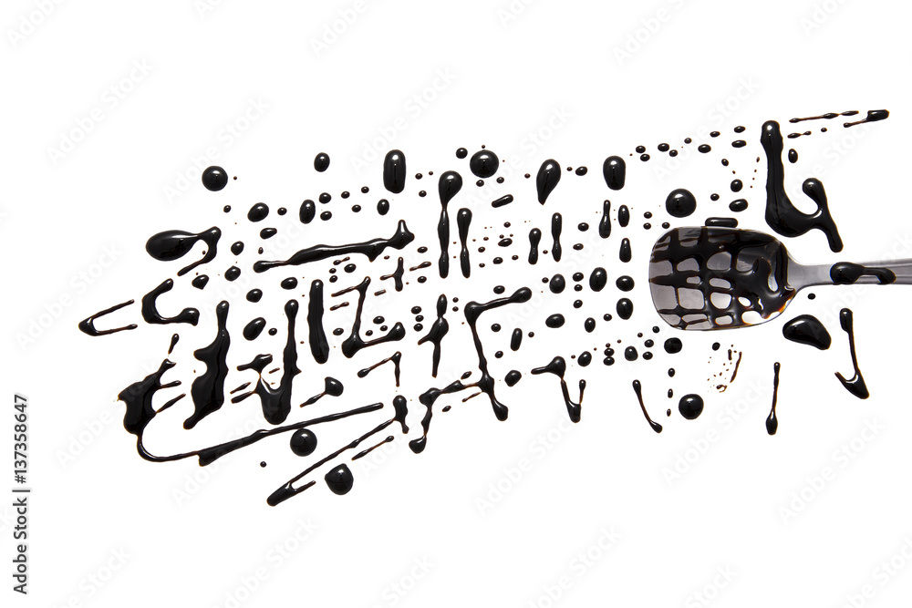 Obraz premium splashes and spilled balsamic vinegar with a spoon. isolated on white background. flat lay, top view