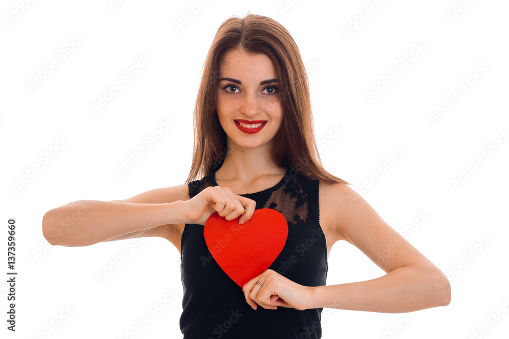 Happy young brunette girl posing with red heart isolated on white background. Saint Valentines Day concept. Love concept. Happy young brunette girl posing with red heart isolated on white background. Saint Valentines Day concept. Love concept.