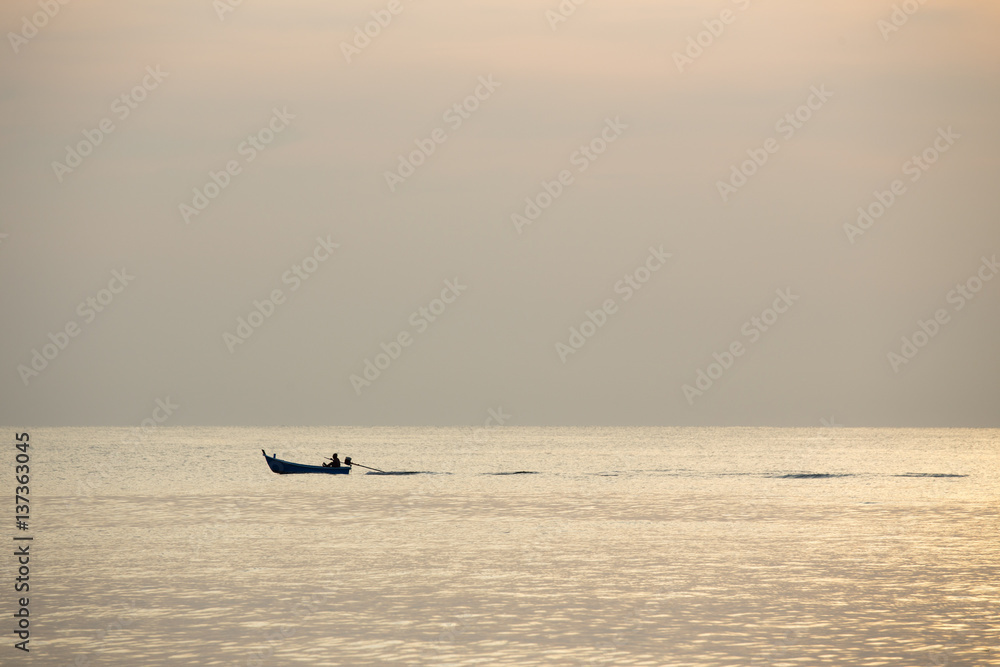 silhouette minimalist of single  fishery boat sail on calm sea in sunrise