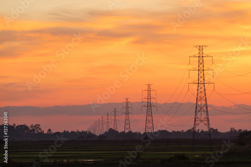 High electric pole at sunset twilight landscape