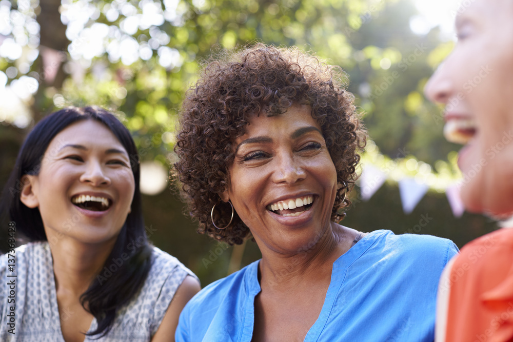 Mature Female Friends Socializing In Backyard Together Mature Female Friends Socializing In Backyard Together