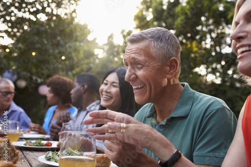 Sticker Group Of Mature Friends Enjoying Outdoor Meal In Backyard