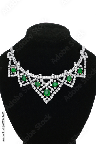 Pendant with green gem stones on black mannequin isolated on white