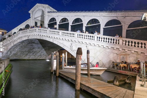 Superb view of the famous Rialto Bridge, Venice, Italy, illuminated by the light of the blue hour after sunset