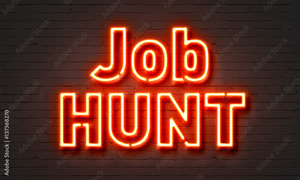 Job hunt neon sign on brick wall background.