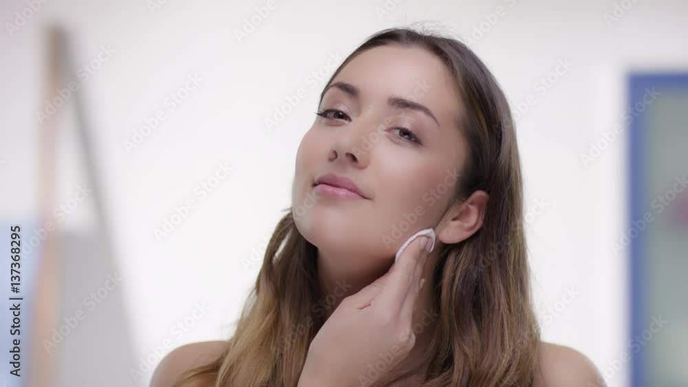 Young attractive woman removes makeup Young attractive woman removes makeup