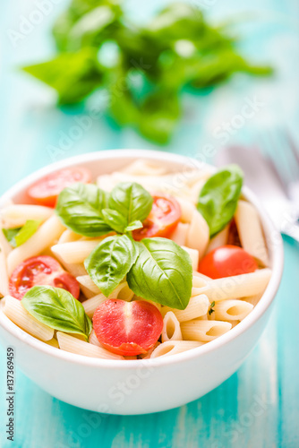 plate of penne pasta with tomato