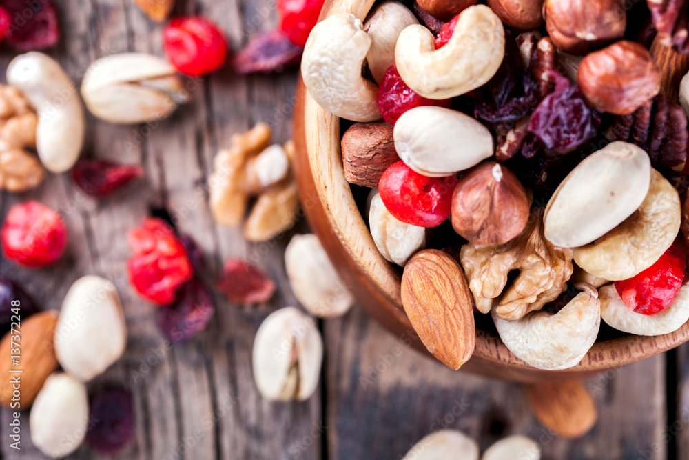 Nuts and dried fruit mix. Concept of Healthy Food. Vintage wooden background. Copy space for Text.Copy space. selective focus Nuts and dried fruit mix. Concept of Healthy Food. Vintage wooden background. Copy space for Text.Copy space. selective focus
