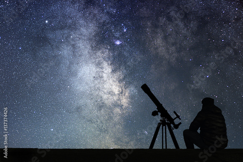 Man with astronomy  telescope looking at the stars. Fototapeta