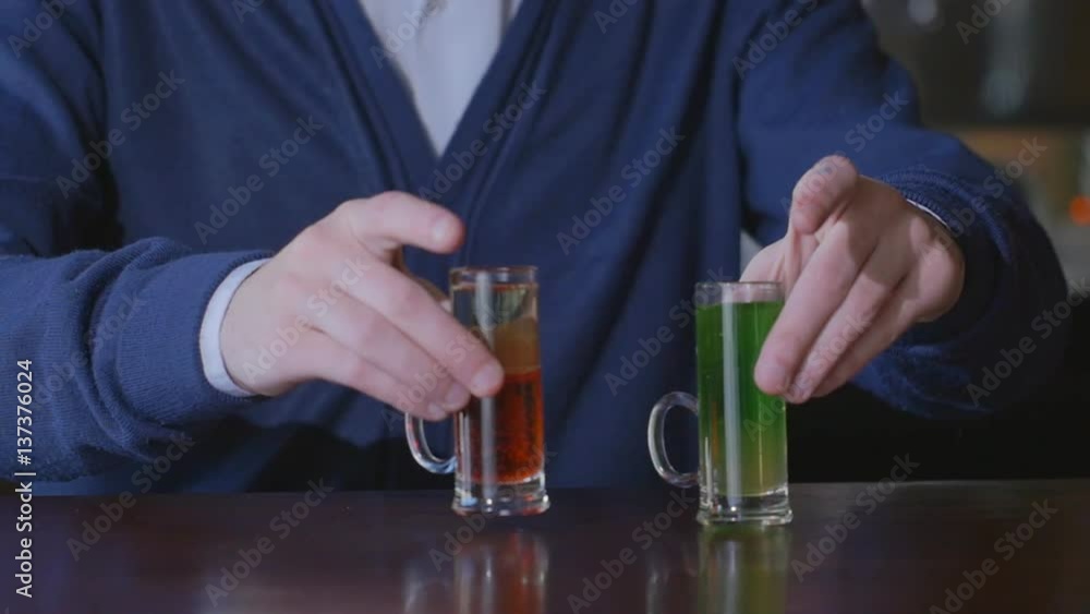 The bartender puts on the bar set of cocktails. The bartender puts on the bar set of cocktails.