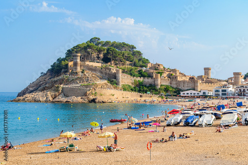 A view of the ancient fortress of Tossa de Mar, in the foreground beach. photo