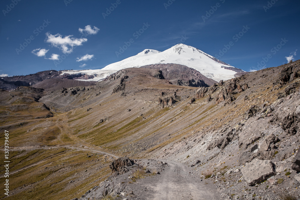 View to the Snow Covered Mountain Top with Blue Sky On Background View to the Snow Covered Mountain Top with Blue Sky On Background