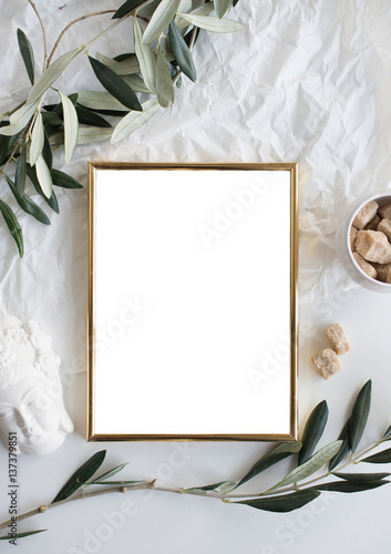 Golden frame mock-up on white tabletop