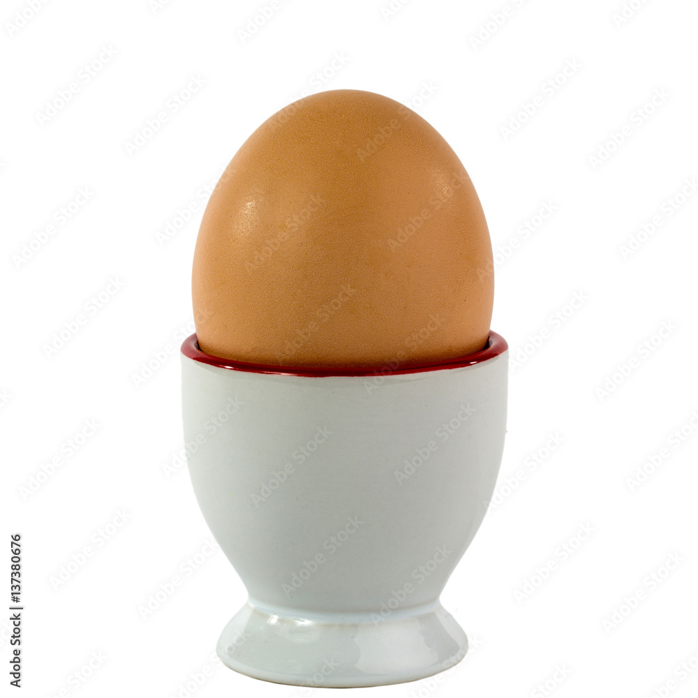 Single egg in egg cup isolated on a white background Single egg in egg cup isolated on a white background