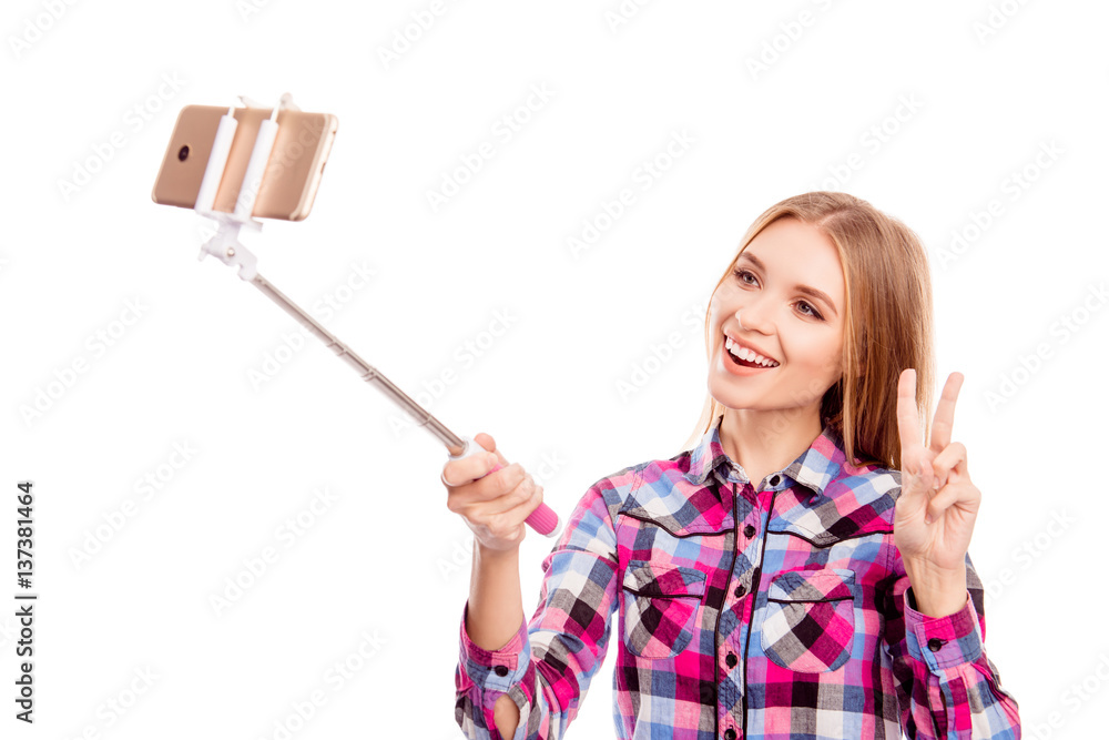 Pretty happy girl using selfie stick to make photo Pretty happy girl using selfie stick to make photo