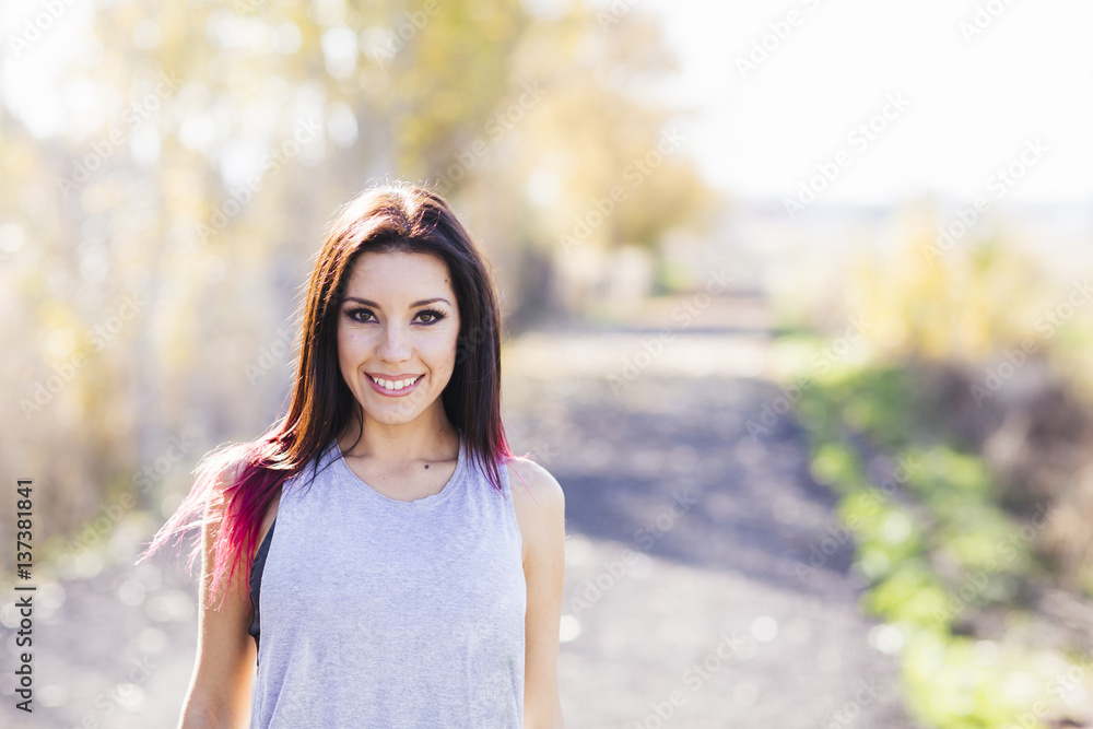Young beautiful sportive woman training outdoor looking at camera. Young beautiful sportive woman training outdoor looking at camera.