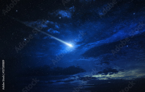 twinkling comet in a blue starry sky