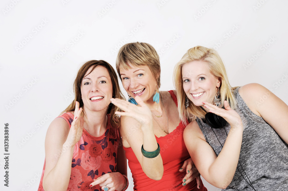 Young and trendy hipster women having fun and dancing together. Studio shot, isolated on white background. Young and trendy hipster women having fun and dancing together. Studio shot, isolated on white background.