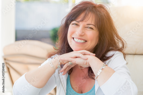 Attractive Middle Aged Woman Smiles On The Patio.