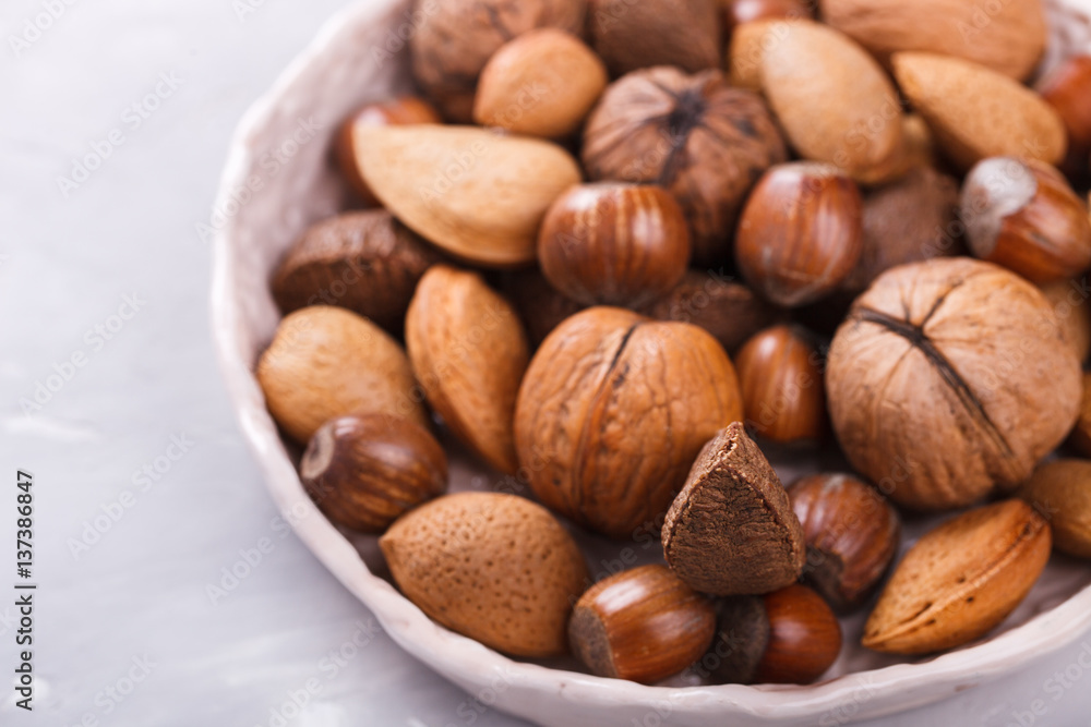 Mixed nuts.Walnuts,Brazil nuts,almonds,hazelnuts.Concept of Healthy Eating.selective focus. Mixed nuts.Walnuts,Brazil nuts,almonds,hazelnuts.Concept of Healthy Eating.selective focus.