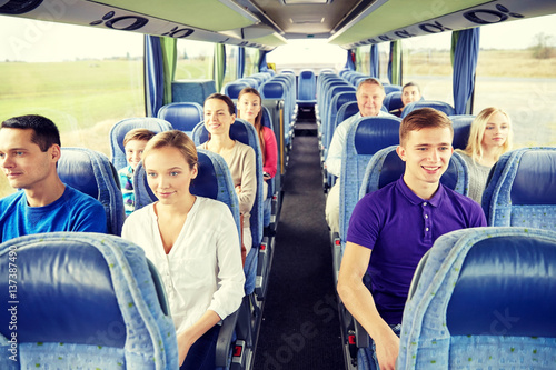 group of happy passengers in travel bus
