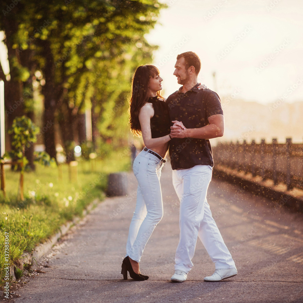 Fototapeta premium young couple dancing tango on the quay