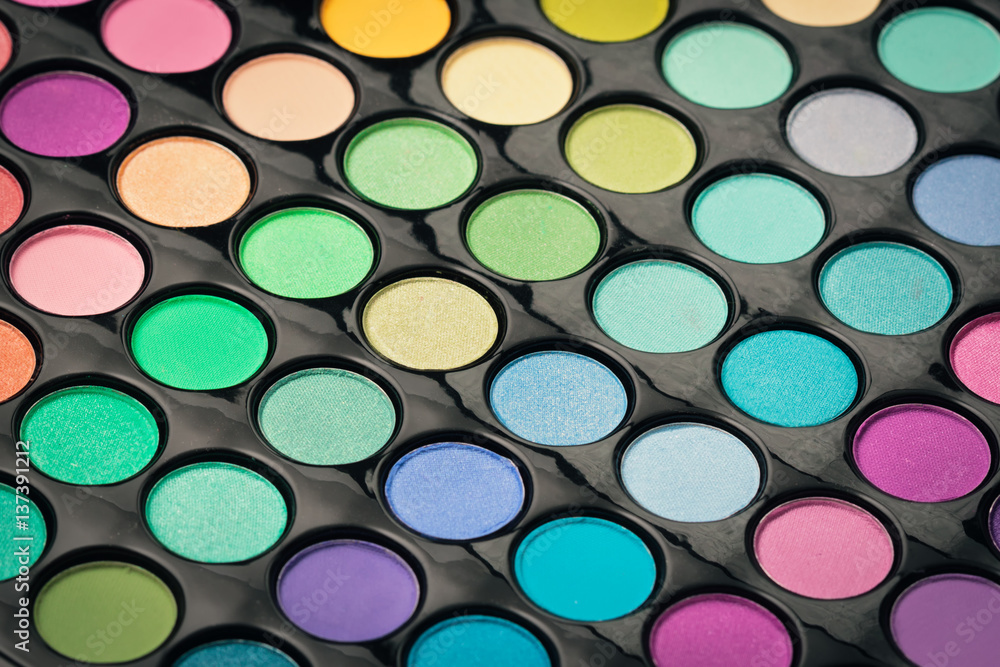 Macro shot of glossy make-up powder. Colorful makeup palette Macro shot of glossy make-up powder. Colorful makeup palette